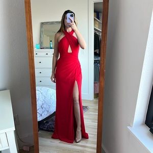 Red La Femme prom or formal dress with slit and low strappy back.
